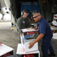 U.S. Coast Guard personnel help off-load relief supplies at the San Juan International Airport on Sept. 22, 2017. (Joe Raedle/Getty Images)